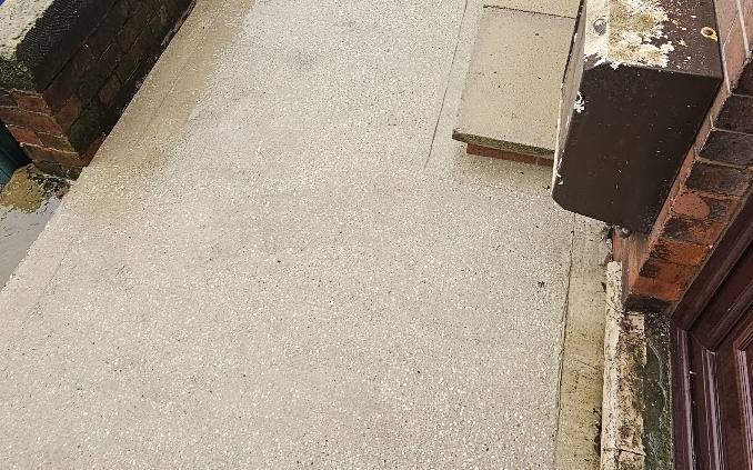 The same concrete patio cleaned back to bare concrete