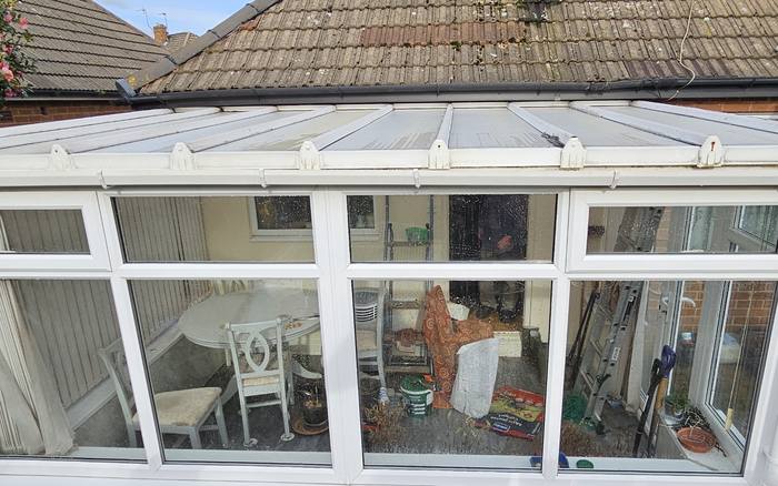 The same conservatory roof cleared of moss and debris