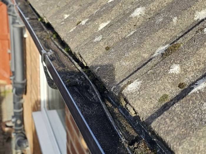 The same gutter run cleared out and flowing again