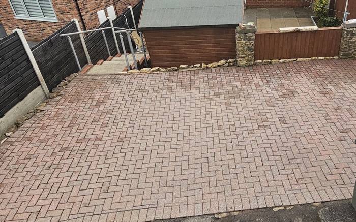 The same rear yard block paving cleaned back to a bright red finish