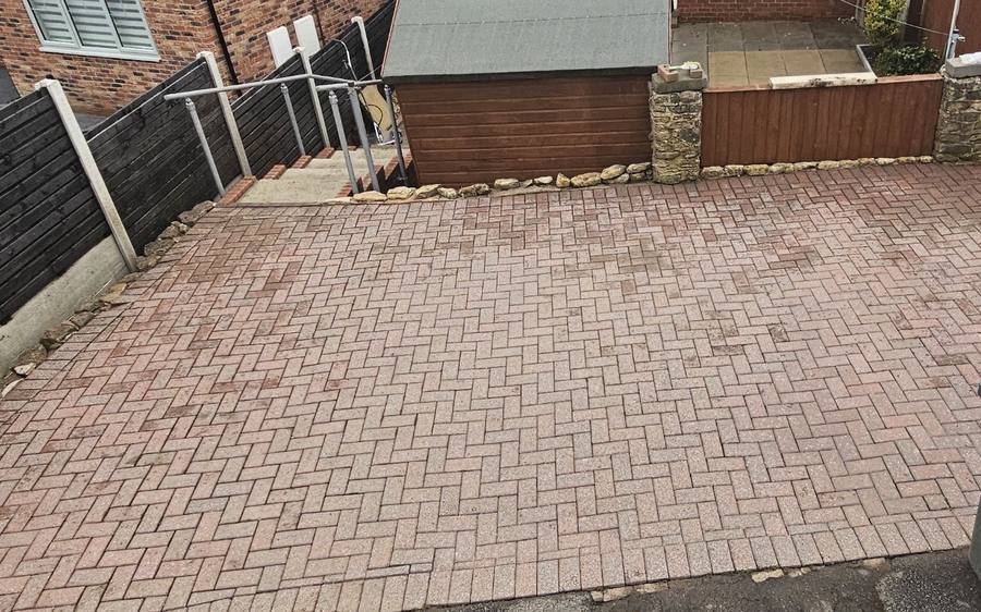 Rear yard block paving cleaned and re sanded, colour fully restored