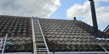 Ladder and pole access set up for a roof clean