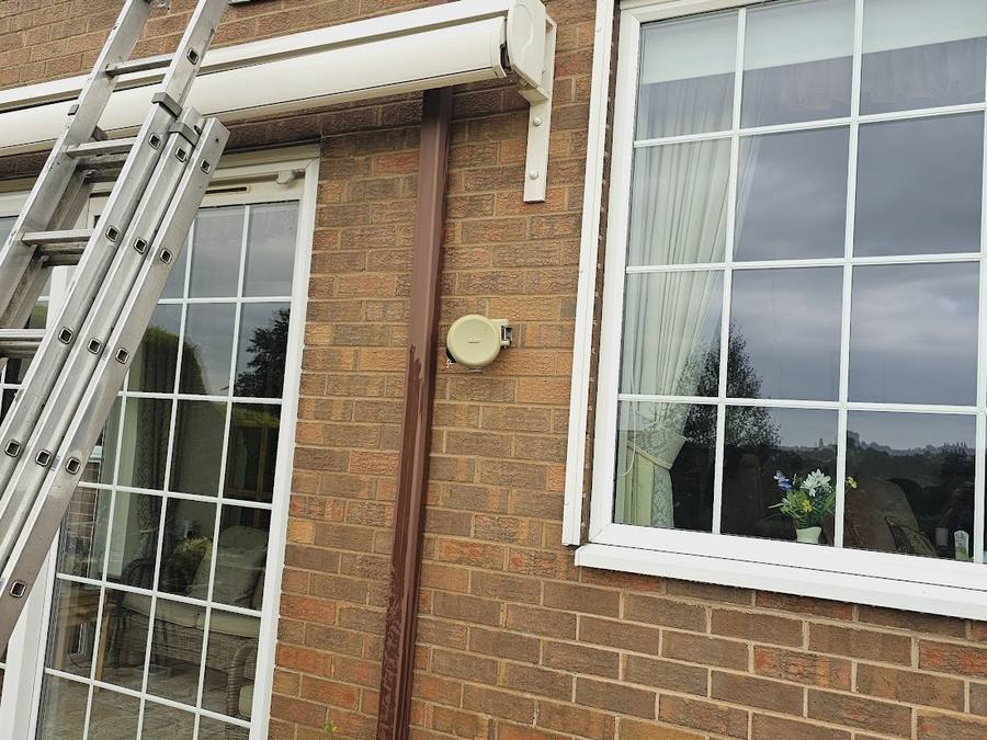 Clean brickwork with ladder access set up alongside the windows